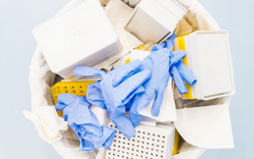 A garbage can filled with latex gloves and lab waste. Read our tips to help reduce waste in laboratories.
