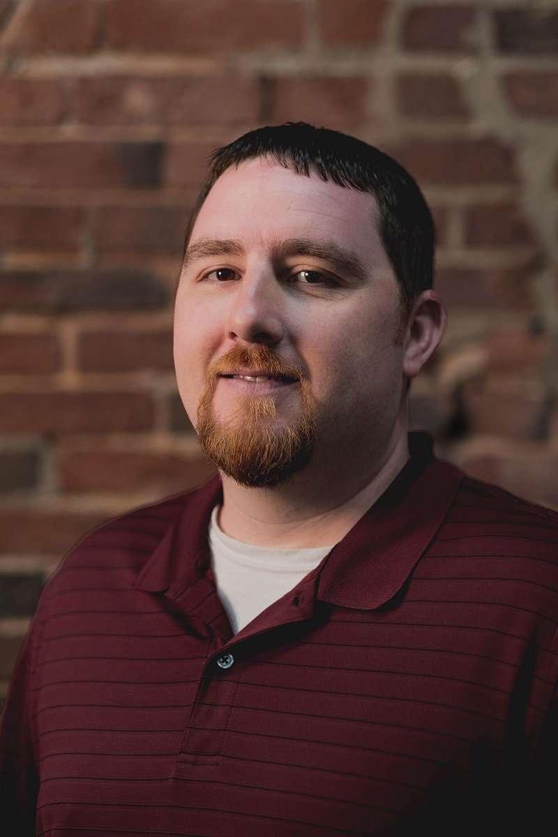 matt-headshot Our Warehouse Associate Matt Romano smiling in front of a brick wall.
