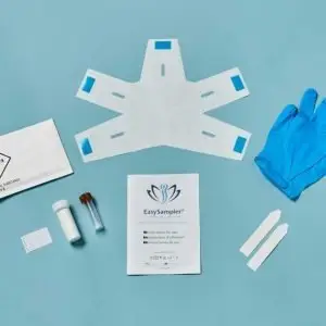 The contents of the EasySampler Complete Stool Collection Kit laid out on a blue surface.