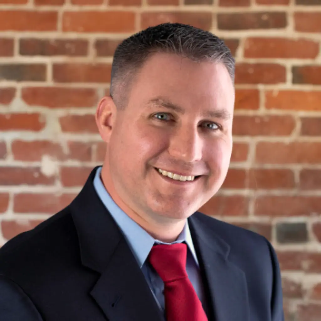 Immundiagnositk, Inc.'s Regional Sales Director, NW & SE, Derek Abbott smiling in front of a brick wall.