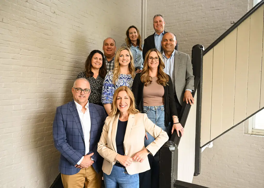 The Immundiagnostik, Inc. team standing on a staircase and smiling.