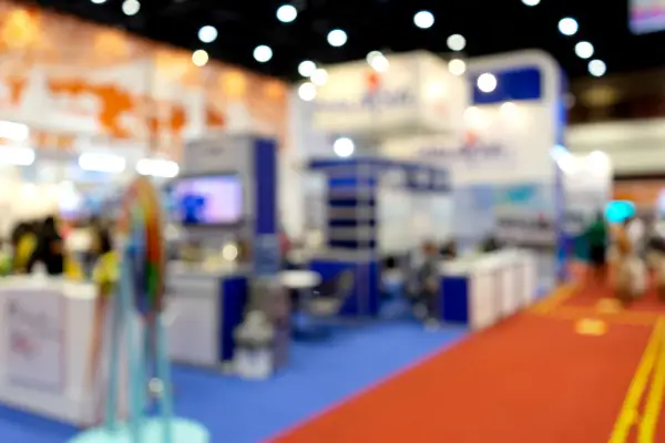 A blurred image of a tradeshow aisle and booths.
