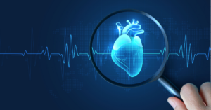 A hand holding a magnifying glass over a heart.